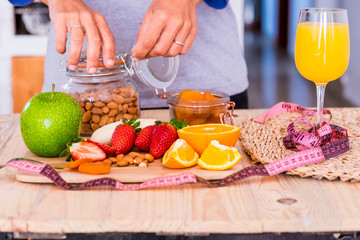 beautiful table full of food like fruits to have a good and nice breakfast at home to lose weight and stay better with yourself - in the table there are banana, framberry, orange, apple and more