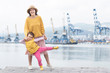 © Alex Desanshe - Happy family, mother, child at the Marina. The mother holds the child's hands and smiling on the background of the sea and  port. The concept of happy parents and children together, healthy lifestyle