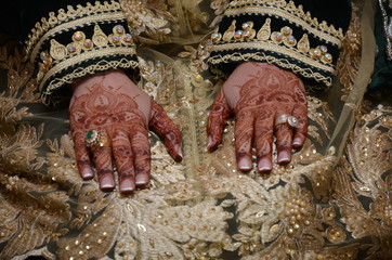 Henna being applied on bride's hand