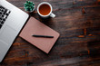 © Ilnur - work space of a businessman. view from above . coffee black note and laptop on the desktop with black note. laptop on wooden background