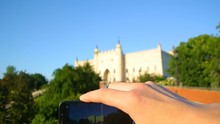 Tourist Hands Take Photo Of Lublin Castle Popular Travel Landmark Close Up Unfocused