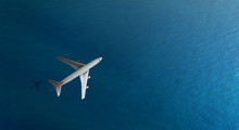 Aerial Top View Of Airplane Flies Over A Sea, View From Above