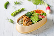 Japanese style bento lunch box with chicken, rice and vegetables