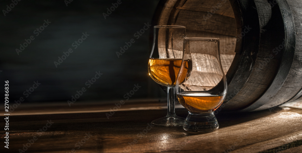 Two glasses with whiskey. They are for professional tasting distillates. - obrazy, fototapety, plakaty 