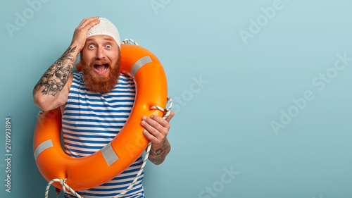 Cuadros en Lienzo Stressed frightened life saver in panic, faces troublesome situation on beach, y