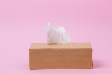 Wall Mural - Box paper tissues with one sticking from the top on pink background