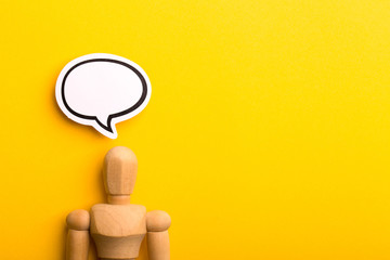 Thinking Concept With Blank Speech Bubble And Wooden Man