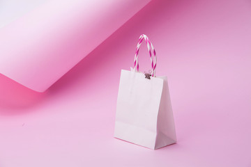 Wall Mural - White shopping bag on abstract pink background for design