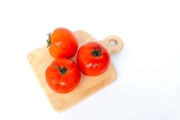 Close up red tomatoes isolated on white background.Tomatoes are vegetables that contain vitamin C and A. And also have anti-oxidants such as lycopene Beta-carotene and phosphorus as well.