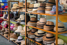 Many Summer Hats And Panama Hats Lie On The Counter In The Shop For Tourists. Summer, Thailand.