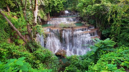 Wall Mural - Waterfall flow standing with forest enviroment high angle view in thailand called Huay or Huai mae khamin in Kanchanaburi province, Thailand., Lockdown.
