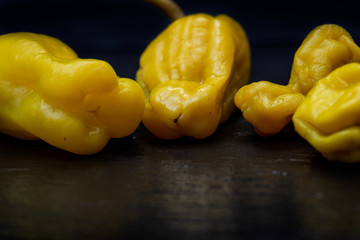 Pickled Golden Greek Peppers, Pepperoncini or Friggitelli (sweet Italian chili pepper) on natural stone background. Capsicum annuum.