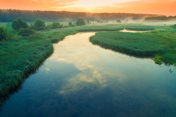 Wall Mural - Early misty morning, sunrise over the lake. Rural landscape in summer. Aerial view