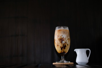 Canvas Print - Iced coffee with fresh milk on wooden table