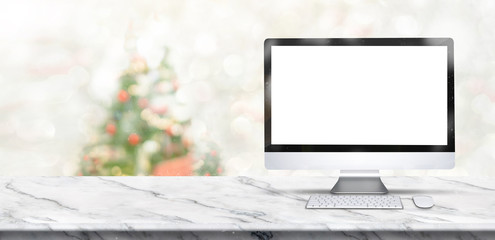 Leinwandbilder - merry christmas banner,Mock up desktop computer on white marble table with blur christmas tree and snow fall background with bokeh light. banner for display of product.
