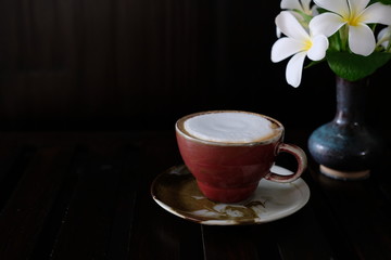 Wall Mural - coffee cup with fresh milk on wooden table