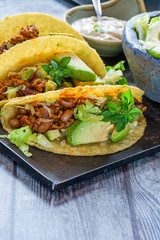 Canvas Print - Smoky Mexican pork and bean tacos with lettuce and avocado salad