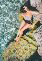 Wall Mural - Woman dressed in retro swim suit sun buthing in the sea lagoon. Healthy skin and safely sunbuthing concept