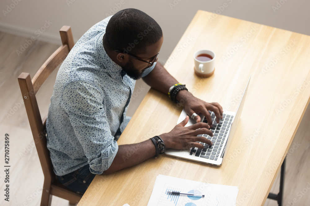 Top view African American employee working with laptop at office Stock ...