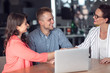 © FS-Stock - Investment adviser giving a presentation to a friendly smiling young couple seated at her desk in the office