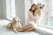 © nuzza11 - Child with a dog. A girl with labradors at home.