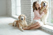 © nuzza11 - Child with a dog. A girl with labradors at home.
