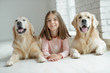 © nuzza11 - Child with a dog. A girl with labradors at home.