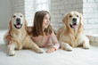 © nuzza11 - Child with a dog. A girl with labradors at home.