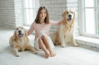 © nuzza11 - Child with a dog. A girl with labradors at home.