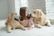 © nuzza11 - Child with a dog. A girl with labradors at home.