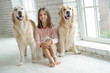 © nuzza11 - Child with a dog. A girl with labradors at home.