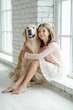 © nuzza11 - Child with a dog. A girl with labradors at home.