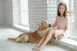 © nuzza11 - Child with a dog. A girl with labradors at home.