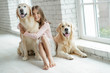 © nuzza11 - Child with a dog. A girl with labradors at home.