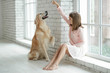 © nuzza11 - Child with a dog. A girl with labradors at home.