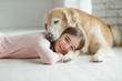 © nuzza11 - Child with a dog. A girl with labradors at home.