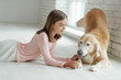 © nuzza11 - Child with a dog. A girl with labradors at home.