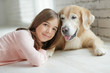 © nuzza11 - Child with a dog. A girl with labradors at home.