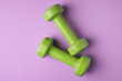 © New Africa - Bright dumbbells on color background, flat lay. Home fitness