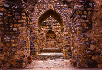 ancient ruins in qutub complex at qutub minar in new delhi, india