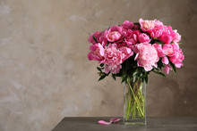 Fragrant Peonies In Vase On Table Against Color Background, Space For Text. Beautiful Spring Flowers
