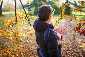 Wall Mural - Man and baby girl outdoors in park