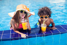 Two Kids Girl And Boy Drink Juice In The Pool And Have Fun. Children And Summer Concept