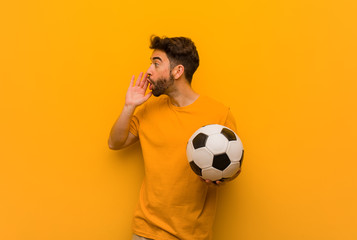 Wall Mural - Young soccer player man whispering gossip undertone