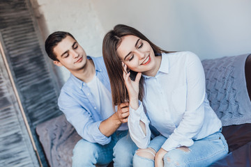 Man and young woman sitting on a couch and want to talk!