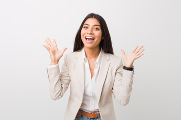 Wall Mural - Young business arab woman isolated against a white background celebrating a victory or success, he is surprised and shocked.