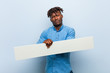 © Asier - Young rasta black man holding a placard smiling confident with crossed arms.