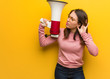 Young cute woman holding a megaphone try to listening a gossip