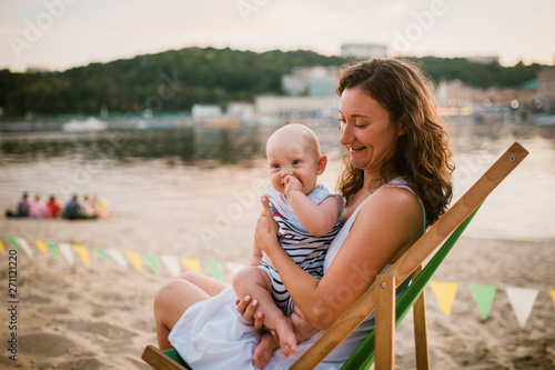 Young Caucasian Woman Beautiful Mother Holds The Child In
