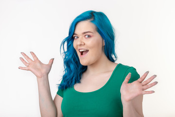 Wall Mural - People, emotions and fashion concept - Beautiful girl with blue hair and joyful face on white background